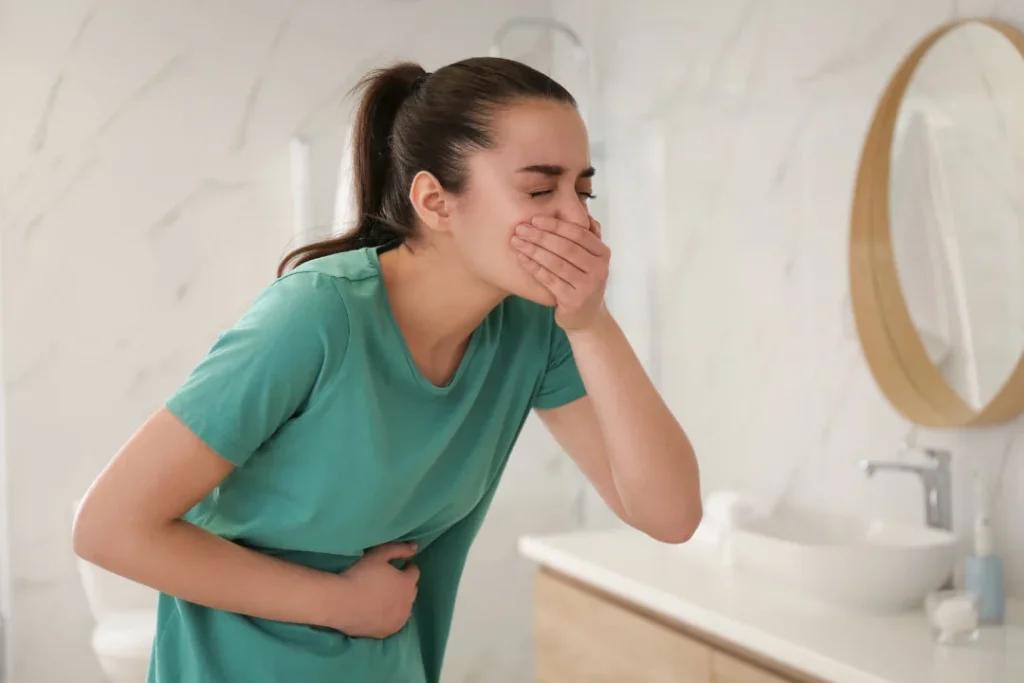 A young girl feeling vomiting.