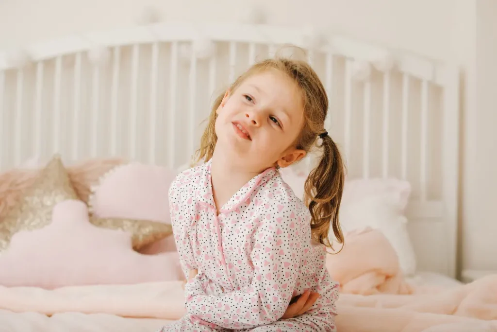 A little girl suffering from stomach pain and unable to sleep