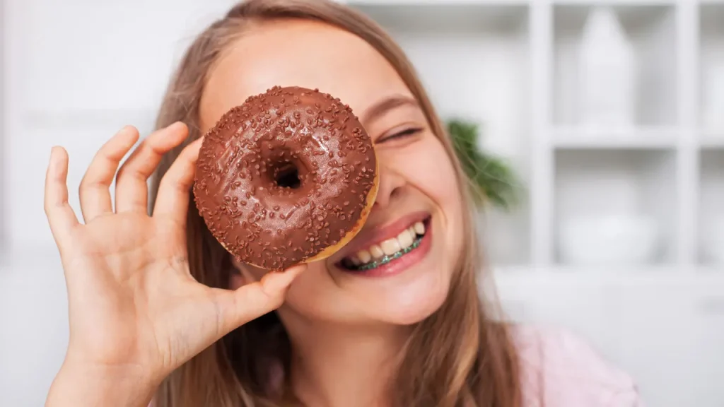 Girl having donut. 